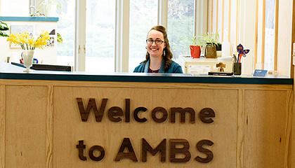Linsey Vandrik, AMBS receptionist, at the front desk in Waltner Hall