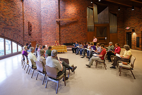 Faculty, staff and students use the Anabaptist Prayer Book during a time of weekly worship.